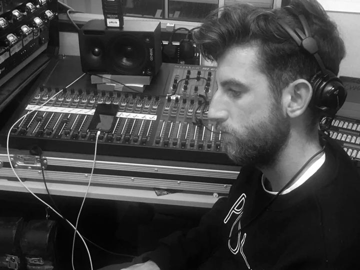Patrick Calvert at a sound desk, in headphones