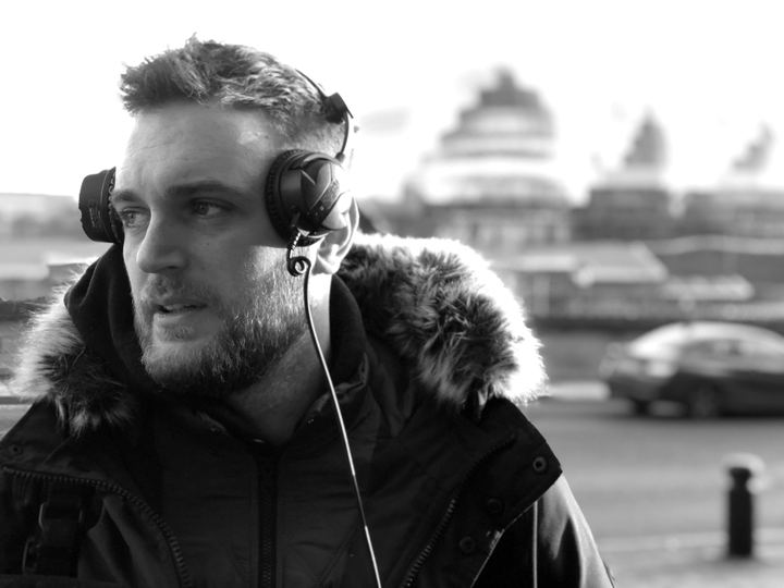 Tom Moore on location, in headphones